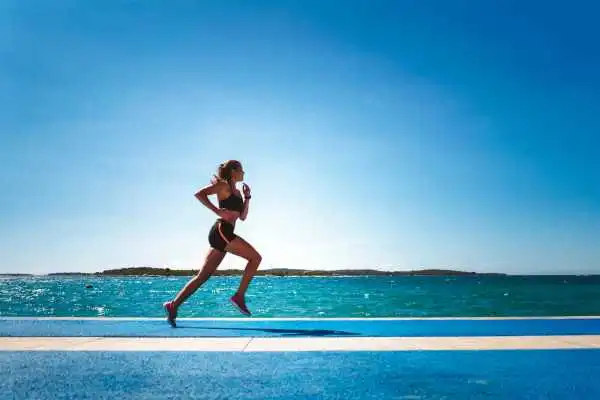 Woman running showing strong leg muscle Wembley